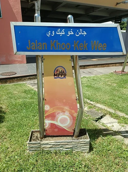 波德申：「Jalan Khoo Kek Wee」為路名，上方另以爪夷文轉寫；照片沒有清楚門牌數字。