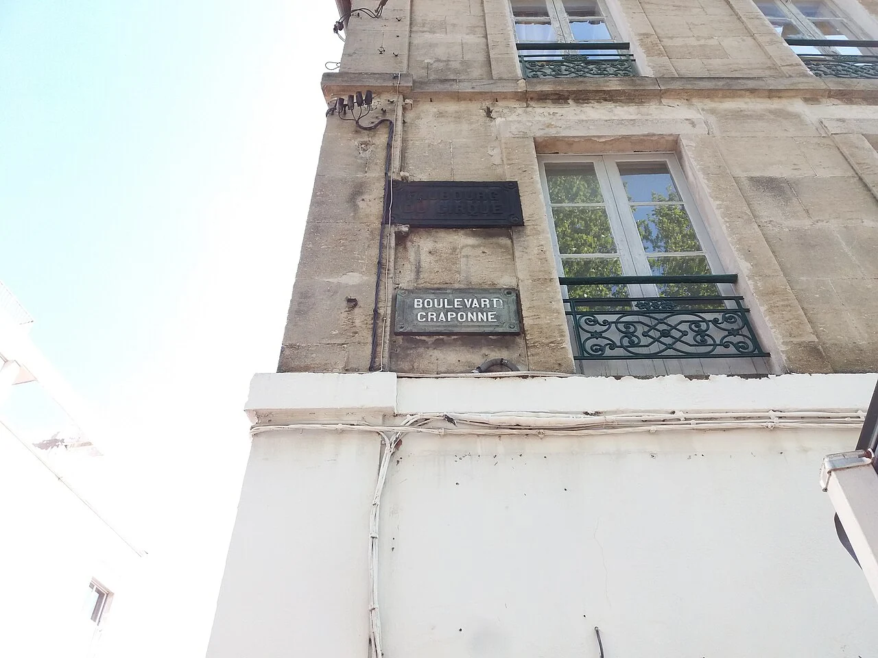 亞爾的實拍街牌。立面下方牌讀「BOULEVARD CRAPONNE」;上方深色矩形另屬畫面資訊,不把它當成同一街名。