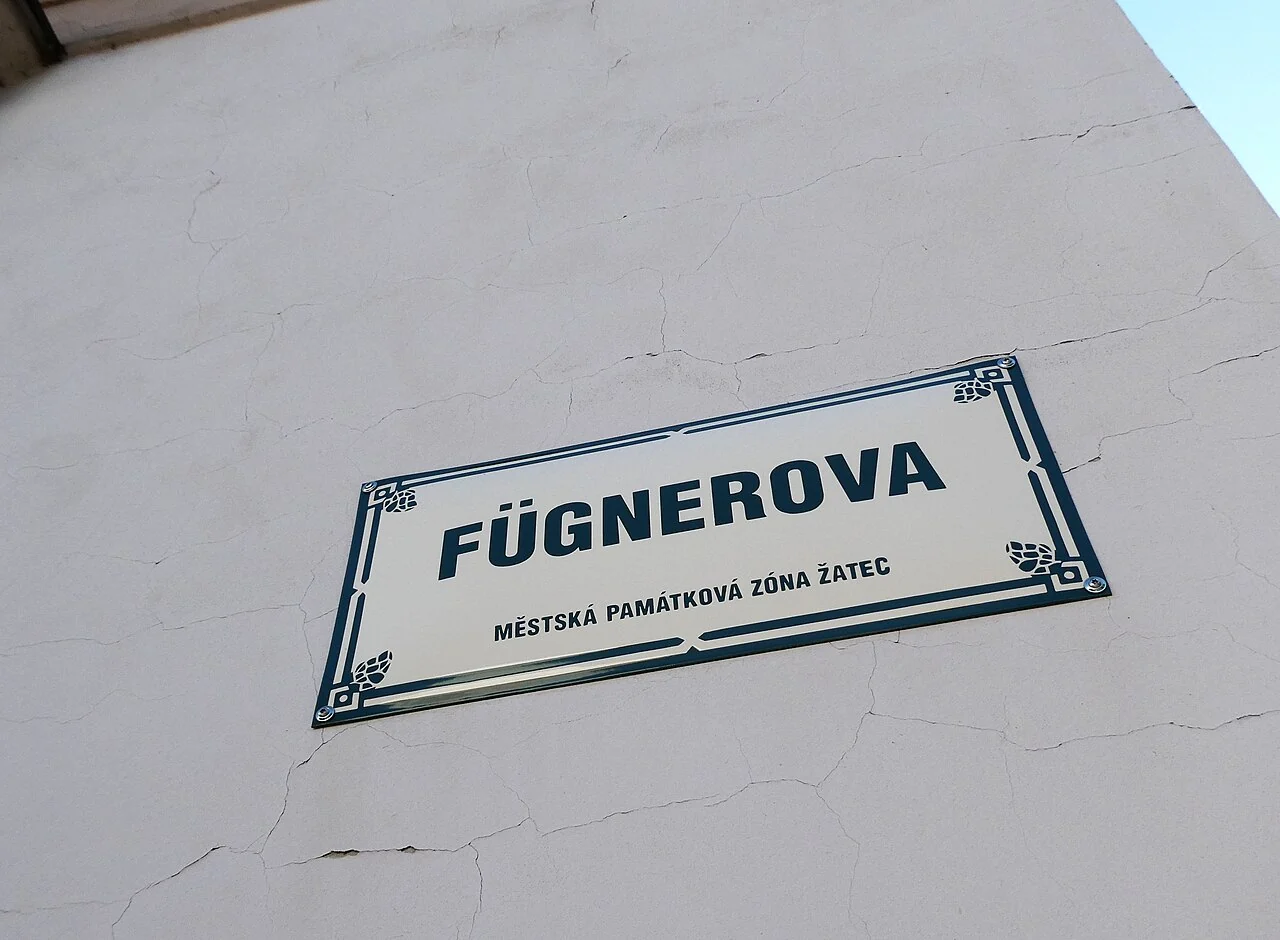 扎泰茨的實拍街牌。「FÜGNEROVA」為街名，下行「MĚSTSKÁ PAMÁTKOVÁ ZÓNA ŽATEC」指扎泰茨城市保護區。