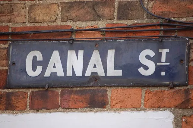牛津傑里科紅磚牆上的CANAL St街牌，白字深藍灰底並帶鏽斑。